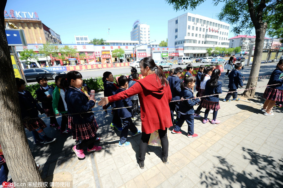 Students walk in rope circle to cross street