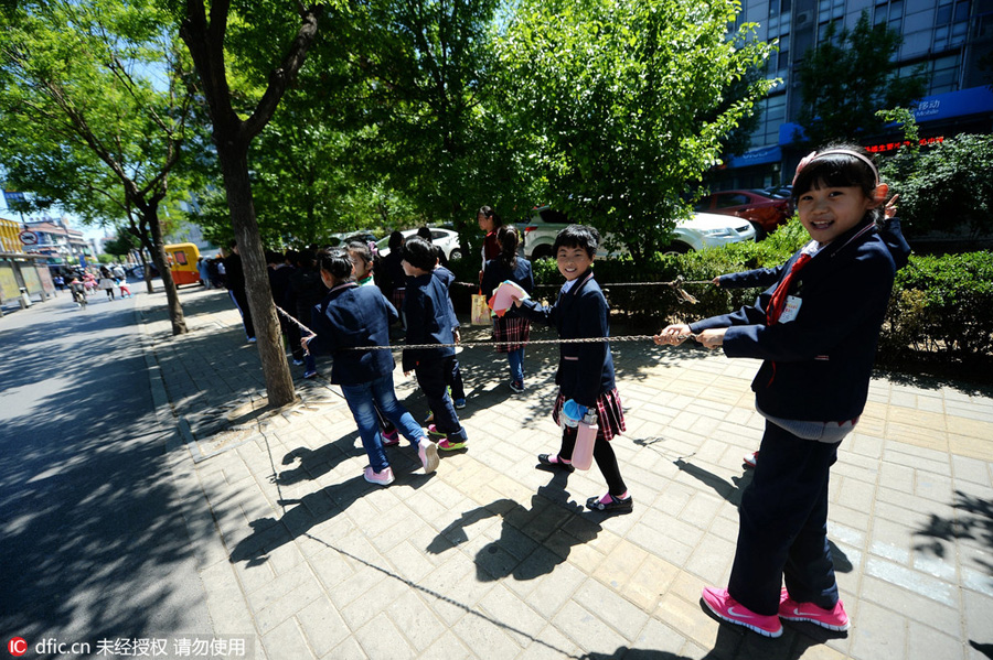 Students walk in rope circle to cross street