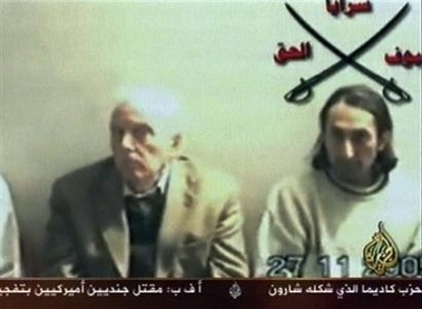 This is an image taken from an Arab Satellite TV channel of two of four peace activists taken hostage in Iraq and broadcast Tuesday Nov. 29, 2005.
