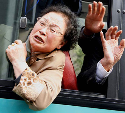 South Koreans wave to their North Korean relatives as they leave for South Korea after a family reunion at North Korea's Mount Kumgang resort March 22, 2006. Scores of Korean families who have not seen their relatives on the divided peninsula in more than a half a century shared tears and embraces during their three-day reunion. 
