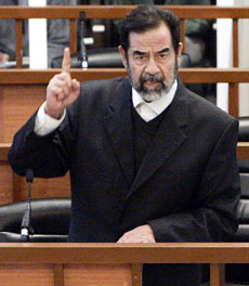 Former Iraqi president Saddam Hussein argues during his trial in Baghdad's Green Zone April 5, 2006. Hussein lashed out at Iraq's Interior Ministry just after his trial resumed on Wednesday, accusing it of killing thousands of Iraqis. 