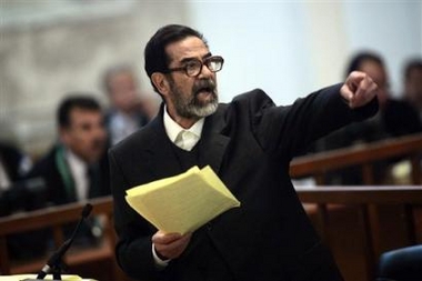Former Iraqi president Saddam Hussein argues with prosecutors while testifying during cross-examination in his trial held in Baghdad's heavily fortified Green Zone, Wednesday April 5, 2006. Saddam Hussein appeared in court Wednesday for questioning by judges and prosecutors in a new session of his trial on charges of killings of Shiites in the 1980s. [AP]