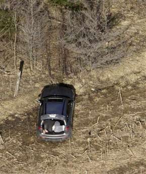 A body is seen in the back of a car in the area where eight men were found dead inside four vehicles near Shedden, Canada, on Saturday April 8, 2006. Police were not disclosing many details about the deaths in rural Ontario, about 20 miles southwest of the city of London, except to say that four vehicles were involved, including a tow truck, and that the dead were all men. murder, slain