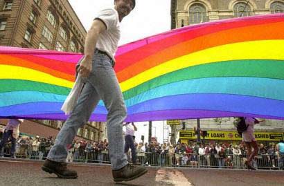 gay, aids, hiv, A participant in San Francisco's 33rd annual Gay Pride Parade helps carry a rainbow flag, June 29, 2003.
