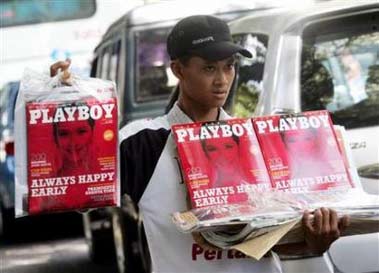 A street vendor sells first copies of a local version of Playboy magazine in Jakarta, Indonesia April 7, 2006. playboy