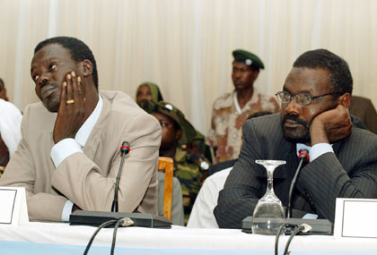 Minni Arcua Minnawi (L), leader of a faction of the rebel Sudan Liberation Army (SLA) and Ibrahim Khalil, leader of the Sudanese Justice and Equity Movement (JEM) participate in a meeting with Sudan government representatives during negotiations on a peace plan for Darfur in Abuja, Nigeria May 2, 2006. The government of Sudan has accepted an 85-page draft settlement but three Darfur rebel factions refused to sign, saying they were unhappy with the proposals on security, power-sharing and wealth-sharing.
