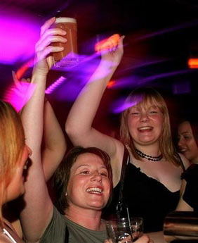 Revellers enjoy themselves in a pub in Newcastle town center, United Kingdom November 23, 2005. Teenage girls in the UK have overtaken boys as binge drinkers for the first time and are now second only behind Irish girls in Europe, according to a report on Thursday. (