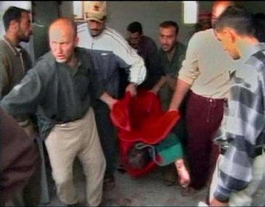An image taken from file footage shot on November 19, 2005 shows a body being carried from a morgue after an incident in Haditha, northwest of Baghdad. U.S. senators demanded on Tuesday that the Bush administration swiftly establish what happened in Haditha where American Marines are suspected of killing 24 unarmed Iraqis. [Reutes]
