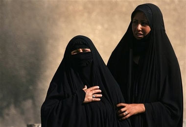 A woman who lost both her son and husband is comforted by her daughter, right, as she grieves near the morgue of Yarmouk hospital in Baghdad, Iraq Sunday, June 18, 2006, following a parked car bomb which detonated in the Um al-Mea'alef neighborhood of southwest Baghdad on Saturday night killing 6 and wounding 22 civilians. [AP Photo]