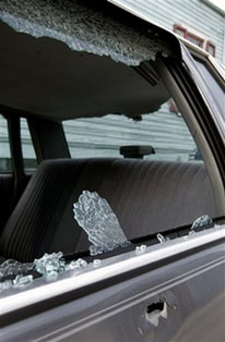 A bullet hole and shattered window are seen on a car on the street at the scene where five young men were killed on Saturday June 17, 2006. Five men, one aged 16, were shot and killed inside a sports utility vehicle at early Saturday. (AP Photo/Alex Brandon) 