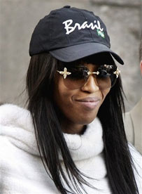 Naomi Campbell is led out of Midtown North police precinct in New York, Thursday, March 30, 2006. Another maid is suing Campbell, claiming the supermodel hit her. (AP Photo/
