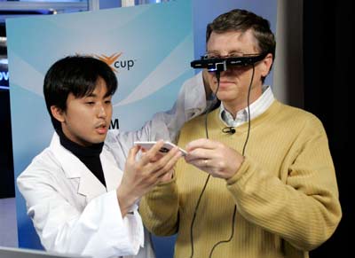 Microsoft's Chairman and Chief Software Architect, Bill Gates (R) receives a demonstration of the "Docterra" medical information management system from Team Japan member Yuichi Shiwaku, competing for the Microsoft Imagine Cup 2006 in Redmond, Washington, June 28, 2006. Seventy-six university student teams will travel to the worldwide finals in India in August with a chance to win up to $25,000 in prizes. [Reuters]