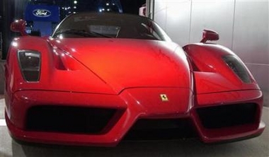 The limited edition Ferrari Enzo is shown at the 2003 New York International Auto Show, April 16, 2003. A woman living in Germany is auctioning off her red Ferrari Enzo sports car and including a little extra in the package -- herself. [Reuters]