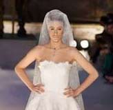 French model Marie de Villepin displays a wedding dress during the Paris haute couture collection in July 2004. De Villepin -- the daughter of French Prime Minister Dominique de Villepin -- has been chosen by the fashion house Givenchy as the model for its latest perfume "Angel or Demon".(