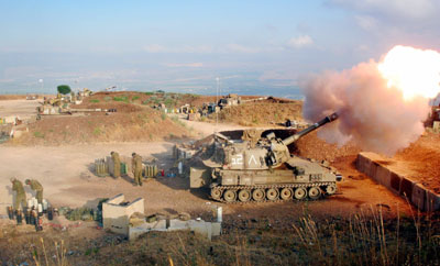An Israeli army 155 mm mobile artillery piece fires into southern Lebanon from a position on the frontier in Zaura July 13, 2006. Israel struck Beirut airport and Hizbollah's television station on Thursday and killed 22 civilians in raids on south Lebanon, intensifying its reprisals after Hizbollah captured two Israeli soldiers and killed eight.
