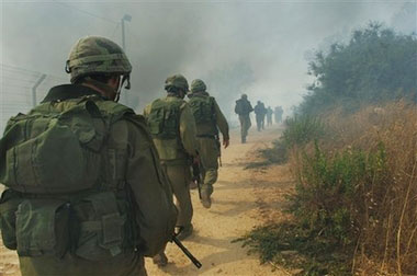 Israeli soldiers advance towards southern Lebanon near the northern Israeli village of Avivim Wednesday July 19, 2006. Fierce firefights between Israeli troops and Hezbollah militants erupted Wednesday along Lebanon's southwestern border with Israel, leaving two Israeli soldiers dead, the Israeli army said. (AP