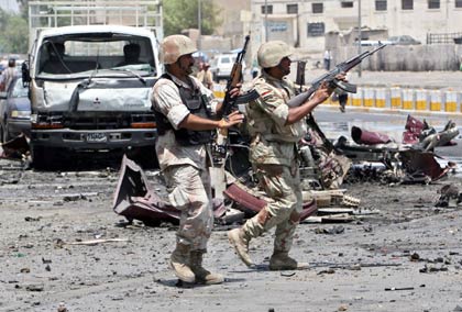 Iraqi soldiers take their position at the site of a car bomb attack in which one man was killed and 15 wounded in central Baghdad July 20, 2006. 