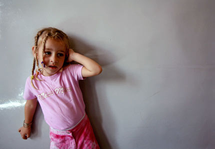 A Lebanese girl living in a camp for evacuees looks on at a school in the city of Zahle, about 55 km (34 miles) north of Beirut July 31, 2006. [Reuters]