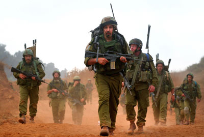 Israeli soldiers walk inside Lebanon near the southern town of Markaba during a ground operation August 12, 2006. 