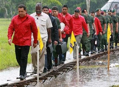 In this image released by Miraflores Press, Venezuela's President Hugo Chavez leads his security guards and government workers during his visit to a livestock support center in Venezuela's Tachira state, Friday, Aug. 18, 2006. (AP Photo/Miraflores Press, Marcelo Garcia, HO)