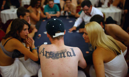 Players take part in the World Strip Poker Championship in London August 19, 2006. Up to 200 strip poker players competed on Saturday to see who will lose their shirts - and more - and who will scoop 10,000 pounds by retaining their clothes and modesty. [Reuters]