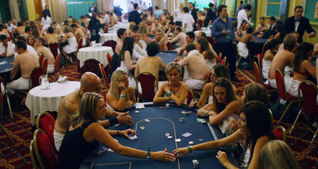 Players take part in the World Strip Poker Championship in London August 19, 2006. Up to 200 strip poker players competed on Saturday to see who will lose their shirts - and more - and who will scoop 10,000 pounds by retaining their clothes and modesty. [Reuters]
