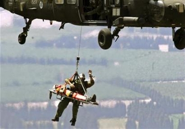 A man is rescued by an Israeli armed forces helicopter after crashing his paraglider in a minefield near the Syrian border September 2, 2006.