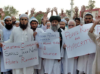 Pakistani Muslims hold placards and chant slogans to condemn remarks by Pope Benedict XVI during a protest after evening prayers at a mosque in Islamabad September 15, 2006.