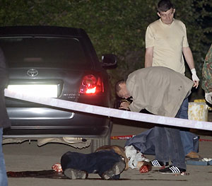 Russian investigators work at the site of an attempt on the life of the first deputy chairman of Russia's Central Bank Andrei Kozlov in Moscow September 13, 2006.