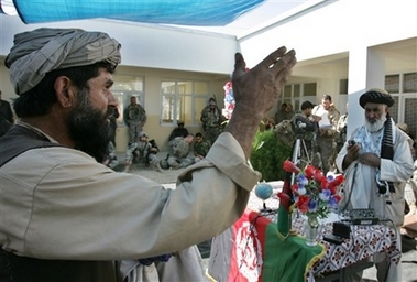 Daulat Khan, left, complains against the state government of Ghazni as the Governor Haji Sher Alam, right, listens during the inauguration of a district administrative building in Ander, Ghazni province of Afghanistan, Sunday Sept. 17, 2006. (AP