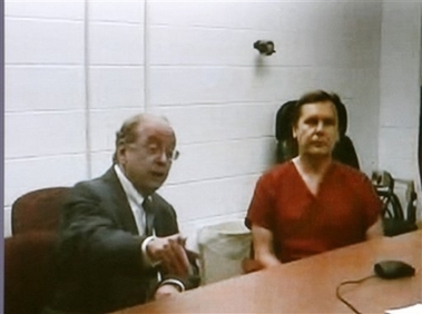 Nicholas Kampf, right and his lawyer Alan Cronheim are seen on a large screen television from the Brentwood, N.H. jail, during his video arraignment in district court in Salem, N.H. Monday, Sept. 18, 2006. Police say Nicholas and his wife Lola Kampf kidnapped their pregnant 19-year-old daughter Katelyn Kampf, and were headed to another state to force her to have an abortion before she escaped. (AP 