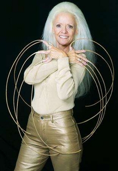 An undated handout photograph released on September 27, 2006 shows Lee Redmond of the U.S. who has won entry into the latest edition of Guinness World Records September 28, 2006 with the world's longest fingernails. REUTERS