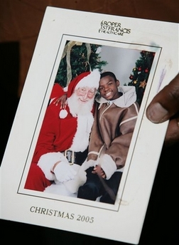 Melba Rainey Thompson, sister of Detra Rainey Simmons, holds a Christmas-season photo of her nephew, Hakiem Rainey, at a news conference, Sunday, Oct. 1, 2006 in West Ashley, S.C. Michael Simmons, 41, is charged with five counts of murder in the deaths of his wife, Detra Rainey Simmons, and her four children, including Hakiem. (AP Photo/Alice Keeney