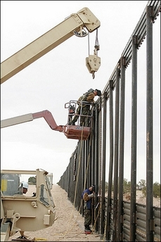National Guard construction personel extend a wall along the US border with Mexico in Arizona, in June 2006. [AFP]