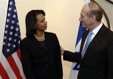 In this photo released by the United States Embassy in Tel Aviv, Israeli Prime Minister Ehud Olmert, right, speaks to United States Secretary of State Condoleezza Rice, left, prior to their meeting in Jerusalem, Wednesday, Oct. 4, 2006. (AP Photo