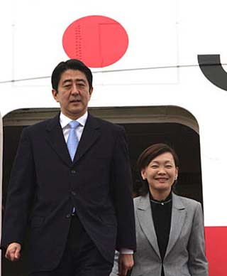 Japan's Prime Minister Shinzo Abe (2nd from L) and first lady Akie Abe disembarks from a plane at the Beijing Capital International Airport in Beijing, October 8, 2006. Abe will have a meeting with Chinese President Hu Jintao in Beijing on Sunday and fly to Seoul for talks with South Korea's President Roh Moo-hyun on Monday. [Newsphoto] 