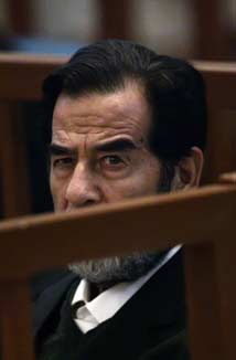 Saddam Hussein listens to a witness testimony during his trial in Baghdad's heavily fortified Green Zone October 9, 2006. Saddam's genocide trial resumed on Monday after chaos reigned at the last session, when he was repeatedly ejected from the courtroom and his lawyers walked out over the sacking of the chief judge. 