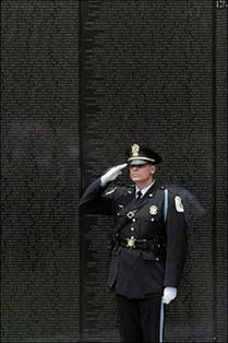 A US Park Service officer salutes at the Vietnam War Memorial, on The National Mall. US President George W. Bush for the first time acknowledged a possible parallel between the raging violence in Iraq and the Vietnam War.(