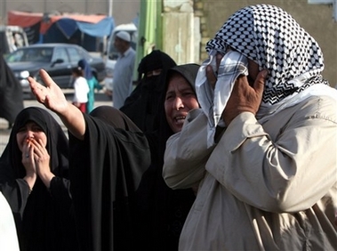 Relatives of police recruits killed in an ambush near Baqouba Sunday cry as they wait to collect bodies in front of Imam Ali hospital in Baghdad's Shiite enclave of Sadr City, Monday Oct. 23, 2006. Gunmen in five sedans ambushed a convoy of buses carrying police recruits near the city of Baqouba 35 miles (55 kilometers) northeast of Baghdad, killing at least 15 and wounding 25 others. (AP