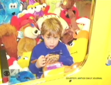 Three-year-old Robert Moore is shown stuck inside a vending machine in this photograph provided to WCCO-TV in Minneapolis by the Antigo (Wis.) Daily Journal.