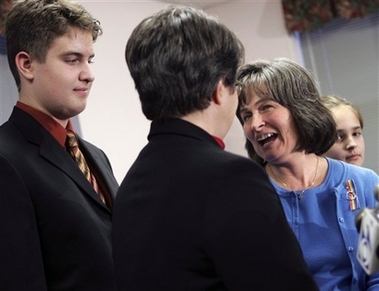 Maureen Kilian, center right, reacts as her partner, Cindy Meneghin, center left, asks to marry her during a news conference regarding a New Jersey Supreme Court ruling on gay marriage in the state in Newark, N.J., Wednesday, Oct. 25, 2006. New Jersey's Supreme Court opened the door to gay marriage Wednesday, asserting that homosexuals are entitled to the same rights as heterosexuals, but leaving it to lawmakers to legalize same-sex unions. Meneghin and Kilian were one of seven same-sex couples who sued the courts for the right to marry. The couple's children Josh, left, and Sarah, stand with their parents. (AP