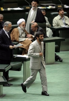 Iranian President Mahmoud Ahmadinejad makes his way to speak in an open session of parliament to debate his nominee as minister of Social Welfare in Tehran, Iran, Sunday, Oct. 29, 2006. Iran's parliament on Sunday approved Abdolreza Mesri as new minister of Social Welfare. In September Ahmadinejad applied the first change to his Cabinet after former social welfare minister, Parviz Kazemi resigned when a presidential evaluation committee confirmed that he failed to accomplish his mission over the past year. (AP 
