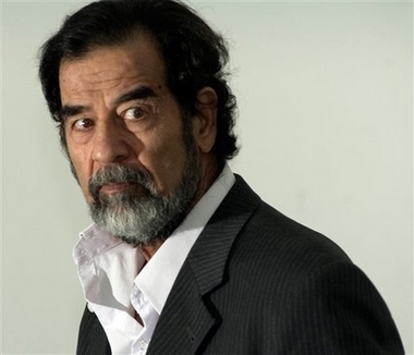In this photo released by the Iraqi Special Tribunal, former Iraqi leader Saddam Hussein is seen as he is questioned by Chief Investigative Judge Raid Juhi, not seen, Aug. 23, 2005 at an unknown location. A verdict in his genocide trial is expected Sunday Oct. 29, 2006. (AP