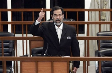 Former Iraqi President Saddam Hussein yells at the court as the verdict is delivered during his trial held under tight security in Baghdad's heavily fortified Green Zone, Sunday Nov. 5, 2006. Iraq's High Tribunal on Sunday found Saddam Hussein guilty of crimes against humanity and sentence him to die by hanging. 