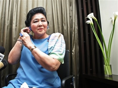 Former Philippine First Lady Meld Marcos, wearing her collection of jewelry she made herself, talks to the media during a break in her own photo shoot for a brochure to launch her own fashion accessories called 'The Imelda Collection' at a posh hotel in Manila Monday Nov. 6, 2006. The flamboyant widow of former Philippine strongman Ferdinand Marcos, is to launch her line of funky jewelry, clothing and shoes in hopes of attracting younger generation not yet born when Imelda and her family ruled the country for 20 years until their ouster in 1986. Mrs. Marcos is to launch her collection later this month. (AP 