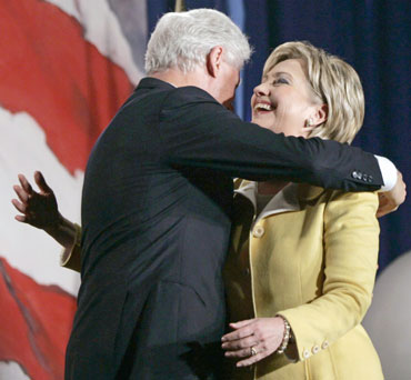 U.S. Senator Hillary Clinton (D-NY) receives a hug from her husband, former U.S. president Bill Clinton (L), after being re-elected during the New York State Democratic Party midterm election night celebration in New York November 7, 2006. 