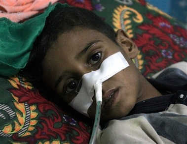 An Iraqi youth, a mortar attack victim, is treated in Sadr City's hospital in Baghdad, Iraq, Wednesday, Nov. 8, 2006. A pair of mortar rounds slammed into a soccer field while young men were playing a game in a Shiite district of Baghdad on Wednesday, as more than 60 people were killed in attacks nationwide. (AP 