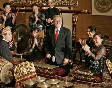 U.S. President George W. Bush, center, is applauded by performers after he played the saron in a traditional gamelan orchestra during a tour of the Asian Civilizations Museum in Singapore Thursday, Nov. 16, 2006. Bush will also attend the annual Asia-Pacific Economic Cooperation summit in Vietnam and visit Indonesia before returning to the United States. (AP