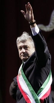 Former presidential candidate Andres Manuel Lopez Obrador waves after being sworn in as the country's 'legitimate president' in front of thousands of supporters at the Zocalo plaza in Mexico City, Mexico, Monday, Nov. 20, 2006. After narrowly losing the country's July 2 elections to President-elect Felipe Calderon, Lopez Obrador has vowed to continue with his parallel government. (AP