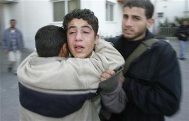 Palestinian relatives of Adham Sahabani, 17, who was killed by Israeli troops, at Odwan hospital in northern Gaza, November 23, 2006.